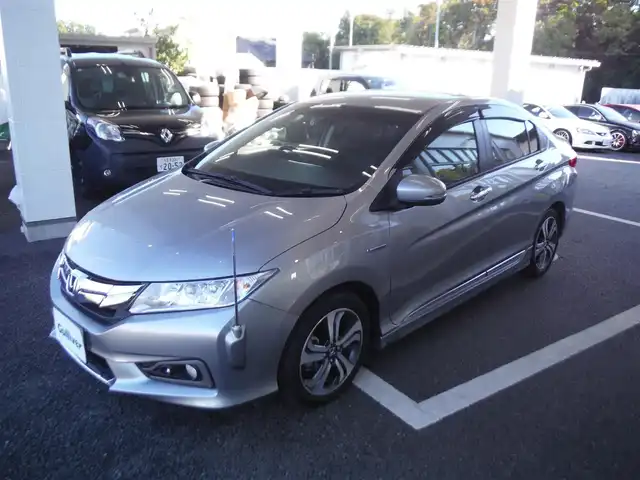 ホンダ グレイス ハイブリッド EX 東京都 2015(平27)年 7.3万km グレー ワンオーナー車/保証書あり/純正ナビ・TV/　BLUETOOTH・HDMI/　バックカメラ・ビルトインETC/ドライブレコーダー/ハーフレザーシート/　前席シートヒーター/あんしんパッケージ/パドルシフト/　クルーズコントロール/モデューロサイドスポイラー/LEDヘッドライト/電動コーナーポール/イルミスカッフプレート/スマートキー×2個