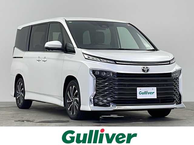 トヨタ ヴォクシー S－Z 千葉県 2024(令6)年 0.7万km ホワイトパールクリスタルシャイン 禁煙車/純正8インチディスプレイオーディオ（コネクティットナビ対応）/フルセグTV　Bluetooth　CD/バックカメラ/全方位カメラ/両側パワースライドドア/ビルトインETC2.0/オートライト/オートハイビーム/LEDヘッドライト/トヨタセーフティセンス/・レーンディパーチャーアラート/・ブラインドスポットモニター/・プリクラッシュセーフティ/・プロアクティブドライビングアシスト/・パーキングサポートブレーキ/・ロードサインアシスト/・レーダークルーズコントロール/コーナーセンサー/電子パーキング/ブレーキホールド/シートヒーター/ハンドルヒーター/パワーバックドア/オートリトラミラー/USB　タイプC　HDMI/純正アルミホイール/純正フロアマット/スマートキー