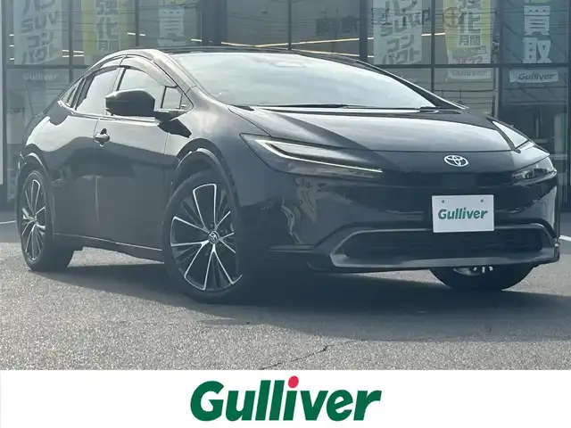 トヨタ プリウス Z 岡山県 2023(令5)年 7.5万km 黒 登録時走行距離74717km/調光パノラマルーフ/純正12.3ディスプレイオーディオ/（AM/FM/TV/BT/MiraCast/HDMI）/パノラミックビューモニター/D/N席シートヒーター/D/N席ベンチレーション/D席パワーシート/メモリーシート/トヨタセーフティセンス/・アダプティブクルーズコントロール/・レーンディパーチャアラート/・オートマチックハイビーム/・クリアランスソナー/・ブラインドスポットモニター/AC100V/ワイヤレス充電/D席メモリーシート/ステアリングヒーター/電子パーキングシステム/ビルトインETC2.0/デジタルインナーミラー/サブウーファー/純正19インチアルミホイール