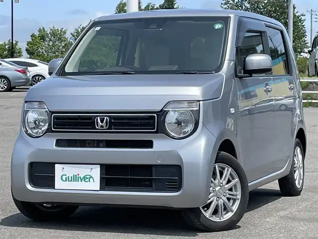 ホンダ Ｎ ＷＧＮ L ホンダセンシング 道央・札幌 2021(令3)年 1.1万km ルナシルバーM ４WD/純正ディーラーOPナビ/CD/DVD/BT/フルセグ/ホンダセンシング/衝突被害軽減ブレーキ/横滑り防止装置/アダプティブクルーズコントロール/レーンキープアシスト/リヤパーキングセンサー/バックカメラ/ビルトインETC/ドライブレコーダー/アイドリングストップ/ECONモード/前席シートヒーター/ステアリングリモコン/電動パーキング/ブレーキホールド/プッシュスタート/スマートキー/ハロゲンヘッドライト/オートライト/オートハイビーム/ヘッドライトレベライザー/電動格納ミラー/ヒーテッドドアミラー/純正フロアマット/ドアバイザー/スペアキー