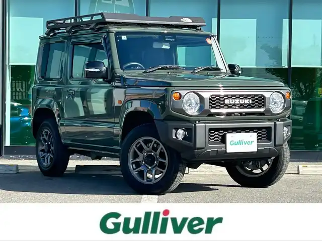 スズキ ジムニー XC 和歌山県 2020(令2)年 0.9万km ジャングルグリーン 衝突軽減ブレーキ/横滑り防止機能/アイドリングストップ/クルコン/シートヒーター/ダウンヒルアシストコントロール/シートカバー/パワーウインドウ/純正AW/ルーフラック/プッシュスタート/スマートキー