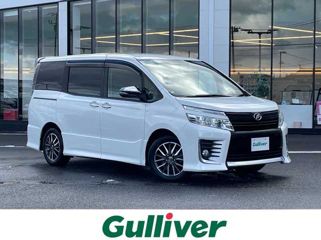 トヨタ ヴォクシー ZS 煌 新潟県 2015(平27)年 6.5万km ホワイトパールクリスタルシャイン 社外ナビ(AVIC-RW09)/(AM/FM/CD/DVD/Bluetooth)/フルセグTV/社外フリップダウンモニター/社外前後ドラレコ型デジタルインナーミラー/両側パワースライドドア/バックカメラ/純正フロアマット/ETC/プッシュスタート/スマートキー/スペアキー×1/LEDヘッドライト/オートライト/保証書