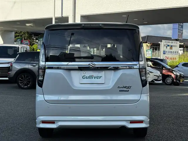 スズキ ソリオ バンディット HV MV 熊本県 2023(令5)年 2.4万km ピュアホワイトP 純正9インチナビ（3A103-59S06）/【フルセグTV/CD/DVD】/全方位カメラ/バックカメラ/両側パワースライドドア/レーダークルーズコントロール/衝突被害軽減ブレーキ/レーンキープアシスト/ヘッドアップディスプレイ/アイドリングストップ/シートヒーター/純正15インチAW/前後ドライブレコーダー/ビルトインETC/オートLEDヘッドライト/ウィンカーミラー/プッシュスタート/ステアリングスイッチ/純正フロアマット/純正ドアバイザー/横滑り防止/盗難防止装置/保証書/取扱説明書