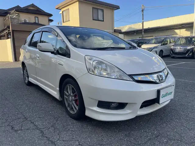 ホンダ フィット シャトル ハイブリッド ナビプレミアムセレ 千葉県 2011(平23)年 11.5万km プレミアムホワイトパール 純正HDDナビ/FM.AM / CD.DVD / TV/バックカメラ/ステアリングリモコン/クルーズコントロール/ハーフレザー/HIDヘッドライト/オートライト/フォグランプ/電動格納式ドアミラー/ウィンカーミラー/ETC/ドアバイザー/フロアマット/スペアキー/保証書/取扱説明書