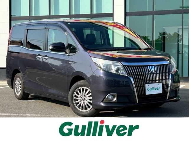 トヨタ エスクァイア ハイブリッド Gi 和歌山県 2014(平26)年 10.5万km ダークバイオレットマイカメタリック 純正ナビ/フルセグTV/バックカメラ/（BT/CD/DVD/MSV）/フリップダウンモニター/車両接近通報/トラクションコントロール/クルーズコントロール/両側パワースライドドア/前方ドラレコ/置くだけ充電/ビルトインETC/レザーシート/プッシュスタート/スマートキー/オートライト/ISOFIX/リアサンシェード/ドアバイザー/nanoe