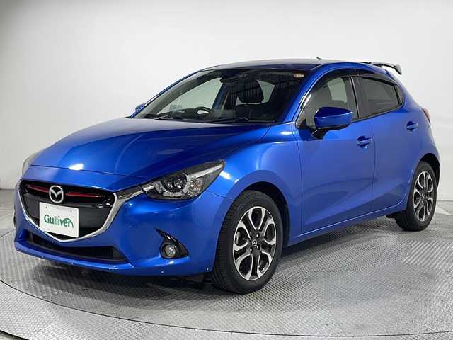 マツダ デミオ XD ツーリング 広島県 2015(平27)年 5.7万km ダイナミックブルーマイカ 純正ナビ　/バックカメラ　/フルセグＴＶ　/リアエアロ　/クルーズコントロール　/衝突軽減ブレーキ　/ＬＥＤヘッドランプ　/オートライト　/フォグランプ　/Ｂｌｕｅｔｏｏｔｈ　/スマートキー　/純正フロアマット　/ＥＴＣ/純正１６インチアルミホイール(185/60/R16)/エアバック（運転席/助手席/サイド/カーテン）