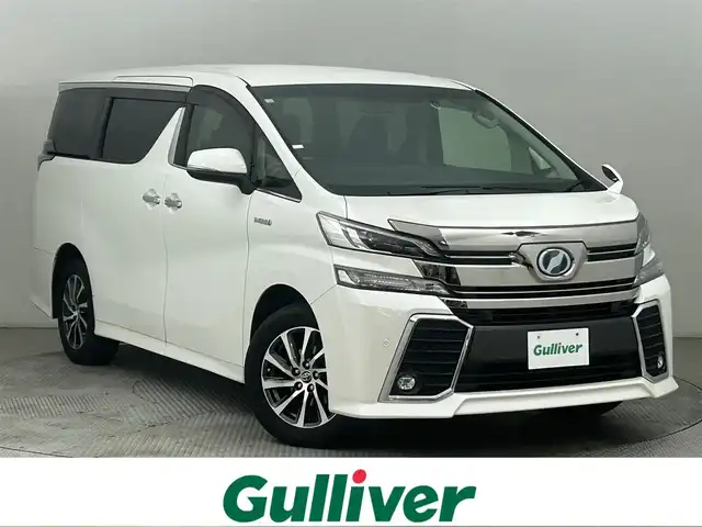 トヨタ ヴェルファイア ハイブリット ZR サイドリフトアップ 道央・札幌 2016(平28)年 3.1万km ホワイトパールクリスタルシャイン ・ワンオーナー/・４WD/・純正10インチナビ/　CD/DVD/SD/BT/フルセグ/・純正フリップダウンモニター/・ビルトインETC/・プリクラッシュセーフティ/・レーダークルーズコントロール/・クリアランスソナー/・ハーフレザシート/・両側パワースライドドア/・LEDヘッドライト/・フォグライト/・オートライト/・プッシュスタート/・スマートキー/・純正フロアマット/・ドアバイザー
