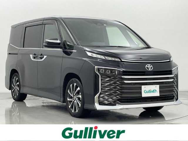 トヨタ ヴォクシー S－Z 熊本県 2022(令4)年 3.1万km グリッターブラックガラスフレーク 禁煙車　/純正10.5インチナビ（CD・DVD・ＡｐｐｌＣａｒＰｌａｙ・ＡｎｄｒｏｉｄＡｕｔｏ・ＢＴ・フルセグ・USB・HDMI）/バックカメラ　/ビルトインＥＴＣ２．０　/両側パワースライドドア　/前後クリアランスソナー　/快適利便パッケージ/・ハンズフリーオートスライド/・セカンドオットマン/・セカンドシートヒーター/・パワーバックドア/トヨタセーフティーセンス/・プリクラッシュセーフティ/・レーントレーシングアシスト/・レーンデェパーチャアラート/・レーダークルーズコントロール/・アダプティブハイビームアシスト/・オートマチックハイビーム/・ロードサインアシスト/・発進お知らせ機能/・フロントクロストラフィックアラート/・レーンチェンジアラート/・緊急時操舵支援/・ドライバー異常対応システム/横滑り防止/アイドリングストップ/前席シートヒーター/ステアリングヒーター/ハーフレザーシート/純正フロアマット/純正１７インチAW/オートライト/三眼ヘッドライト/フォグライト/スマートキー/プッシュスタート/保証書/