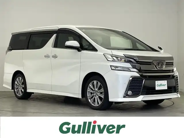 トヨタ ヴェルファイア Z Aエディション ゴールデンアイズ 滋賀県 2017(平29)年 6.1万km ホワイトパールクリスタルシャイン 禁煙車/純正ナビ/（CD/DVD/SD/Bluetooth/フルセグTV）/バックカメラ/純正フリップダウンモニター/前方ドライブレコーダー/ビルトインETC/両側電動スライドドア/プリクラッシュセーフティー/パーキングサポートブレーキ/クリアランスソナー/ウッドコンビステアリング/レーダークルーズコントロール/ステアリングリモコン/ハーフレザーシート/電動パーキングブレーキ/オートホールドブレーキ/オートリトラーミラー/純正フロアマット/純正アルミホイール