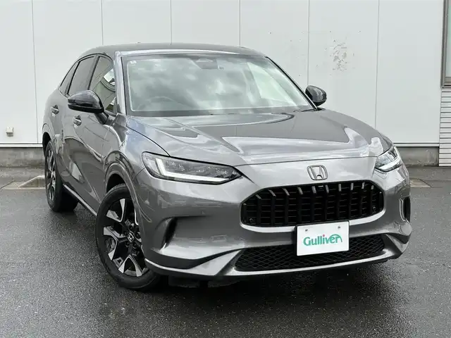 ホンダ ＺＲ－Ｖ ハイブリッド e:HEV Z 三重県 2024(令6)年 0.5万km スーパープラチナグレーメタリック マルチビューカメラシステム/ホンダコネクトディスプレー(9インチワイドディスプレイ/AppleCarPlay/AndroidAuto/Bluetooth/インターナビ/地デジTV/AM/FM/ハンズフリー機能/先読みエコアシスト)/ブラインドスポットモニター/ホンダセンシング(衝突軽減ブレーキ/誤発進抑制/後方誤発進抑制/近距離衝突軽減ブレーキ/歩行者事故低減ステアリング/路外逸脱抑制/渋滞追従機能付アダプティブクルーズコントロール/車線維持支援システム/トラフィックジャムアシスト/先行車発進お知らせ/標識認識/オートハイビーム/ブラインドスポットインフォメーション/パーキングセンサーシステム/後退出庫サポート)/ETC2.0/ドライブレコーダー/ステアリングヒーター/シートヒーター(前席)/ワイヤレス充電器/パワーバックドア/ステアリングスイッチ/パドルシフト/パワーシート(前席)/ドライビングポジションシステム(運転席)/LEDヘッドランプ/アクティブコーナーリングライト/ダウンサス(RSR(Ti2000))/スペアキー