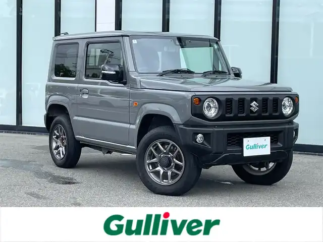 スズキ ジムニー XC 大阪府 2024(令6)年 1.5万km ミディアムグレー 社外ナビ　/　 ＴＶ/CD/DVD/Bluetooth　/バックモニター　/衝突軽減ブレーキ/リアコーナーセンサー　/前席シートヒーター　/スマートルームミラー/クルーズコントロール/レーンキープアシスト　/アイドリングストップ/前方ドライブレコーダー/純正フロアマット/純正16インチアルミホイール/ルーフレール/プッシュスタート　/スマートキー　/ＥＴＣ/ＬＥＤ