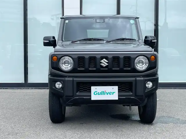 スズキ ジムニー XC 大阪府 2024(令6)年 1.5万km ミディアムグレー 社外ナビ　/　 ＴＶ/CD/DVD/Bluetooth　/バックモニター　/衝突軽減ブレーキ/リアコーナーセンサー　/前席シートヒーター　/スマートルームミラー/クルーズコントロール/レーンキープアシスト　/アイドリングストップ/前方ドライブレコーダー/純正フロアマット/純正16インチアルミホイール/ルーフレール/プッシュスタート　/スマートキー　/ＥＴＣ/ＬＥＤ