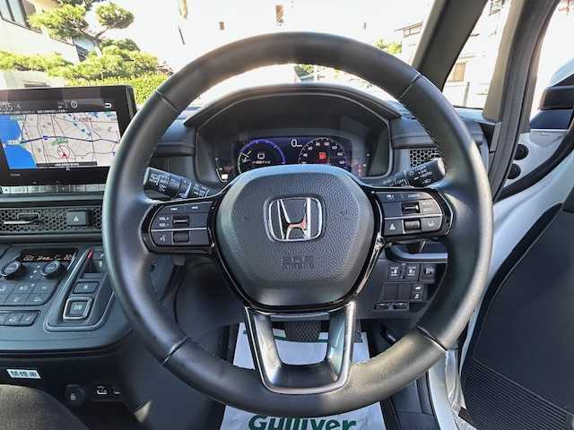 ホンダ ステップワゴン スパーダ eHEV 大阪府 2023(令5)年 2万km プラチナホワイトパール 純正9型ナビ(BT/CD/DVD/SD/フルセグ)/バックカメラ/フリップダウンモニター/ブラインドスポットモニター/衝突被害軽減システム/レーンキープアシスト/コーナーセンサー/アダクティブクルーズコントロール/オートライト/オートマチックハイビーム/純正アルミホイール/純正フロアマット/両側パワースライドドア/電動リアゲート/電動格納ミラー/ドライブレコーダー/ETC/プッシュスタートボタン
