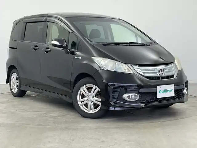 ホンダ フリード ハイブリット ジャストセレクション+ 新潟県 2013(平25)年 9.8万km プレミアムスパークルブラックパール クルーズコントロール/両側パワースライドドア/横滑り防止装置/ＥＴＣ・ステアリングスイッチ/両側パワースライドドア/純正ディーラーオプションナビ/フルセグテレビ/スタッドレスタイヤ１５インチ