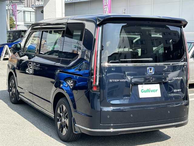 ホンダ ステップワゴン スパーダ eHEV 福岡県 2023(令5)年 1.8万km ミッドナイトブルービームM ワンオーナー/純正SDナビ（LXM-２３７VFLi)/(AM/FM/CD/DVD/BT/フルセグTV）/バックカメラ/レーダークルーズコントロール/レーンキープアシスト/前後クリアランスソナー/パドルシフト/前席シートヒーター/デジタルインナーミラー/ブラインドスポットモニター/パワーバックドア/両側パワースライドドア/三列シート/ハーフレザーシート/ETC2.0/LEDライト/純正16インチアルミホイール/純正フロアマット/スマートキー/スペアキー×１/保証書/取扱説明書/記録簿