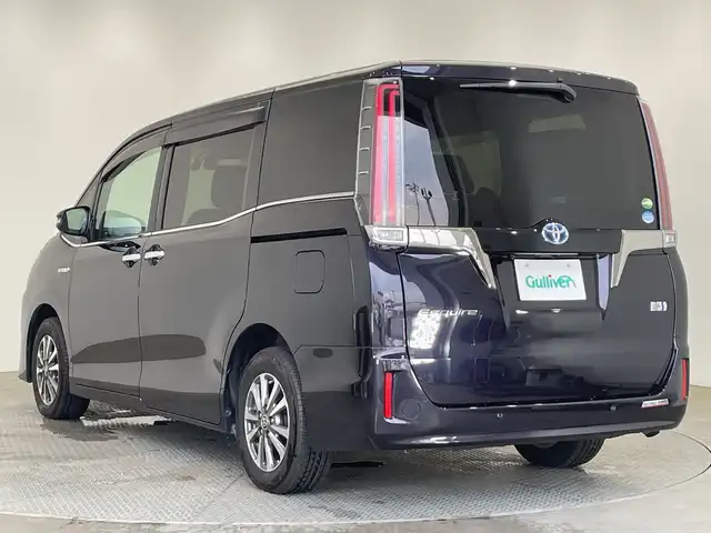 トヨタ エスクァイア ハイブリッド 栃木県 2019(令1)年 3.8万km スパークリングブラックパールクリスタルシャイン 純正10インチナビ/（CD/DVD/Bluetooth/SD/iPod）/バックカメラ/純正ビルトインETC/トヨタセーフティセンス/・プリクラッシュセーフティ/・レーンディパーチャーアラート/・オートマチックハイビーム/・先行発進車お知らせ/・クリアランスソナー/PKSB/前方ドラレコ/両側パワースライドドア/ハーフレザーシート/シートヒーター/禁煙車/ステアリングヒーター/フリップダウンモニター/オートライト/LEDヘッドライト/AC100V電源/スマートキー/プッシュスタート/ステアリングスイッチ/電動格納ミラー/純正アルミホイール/純正フロアマット