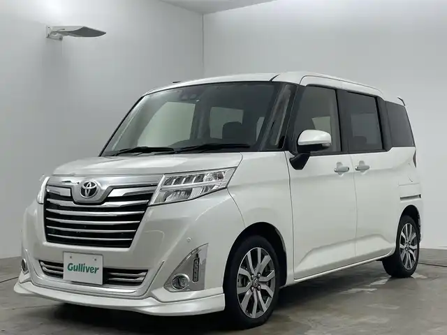トヨタ ルーミー カスタムG－T 広島県 2020(令2)年 4.5万km パールホワイトⅢ 純正９インチナビ	/【ナビ/フルセグ/Bluetooth/DVD】	/パノラミックビューモニター	/クルーズコントロール	/オートハイビーム	/LEDヘッドライト（AUTO機能付き）	/ビルトインETC2.0	/前席シートヒーター	/衝突軽減ブレーキシステム	/車線逸脱防止システム	/横滑り防止装置	/踏み間違い防止装置/純正ドライブレコーダー（前）	/純正15インチアルミ	/コーナーセンサー（前後）	/社外フロントスポイラー/純正フロアマット	/ステアリングスイッチ	/チルトステアリング/シートリフター/シートバックテーブル/ウィンカーミラー	/プッシュスタート