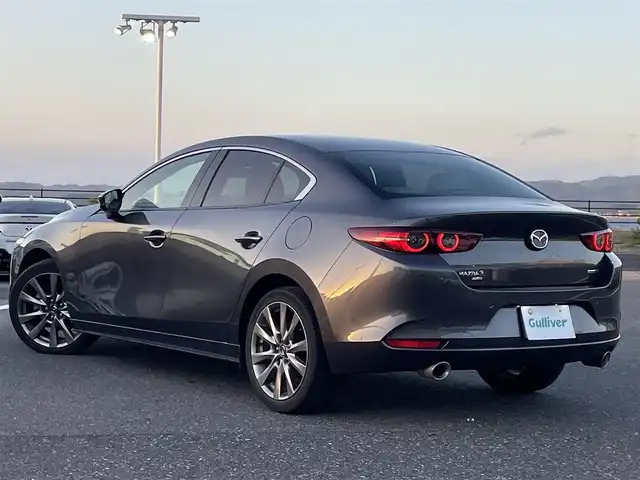 マツダ マツダ３セダン X Lパッケージ 島根県 2019(令1)年 8.2万km マシーングレープレミアムM 登録時走行距離　82602km/４WD/純正ナビ/Bluetooth/DVD/AM/FM/CD/USB)/BOSEサウンド/フルセグテレビ/追従型クルーズコントロール/純正アルミ１８インチ/全周囲カメラ/ETC/パワーシート（D席）/メモリーシート/シートヒーター（DN席）/レーンキープアシスト/ステアリングヒーター/ブラインドスポットモニター/ヘッドアップディスプレイ