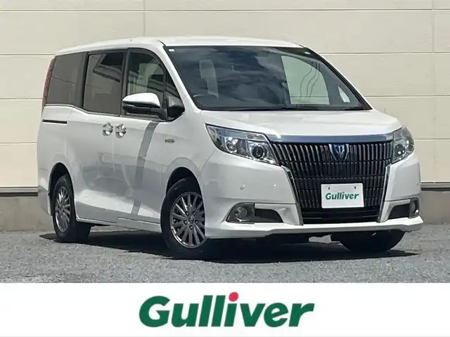 トヨタ エスクァイア ハイブリッド Gi 茨城県 2015(平27)年 5.4万km ホワイトパールクリスタルシャイン ワンオーナー/両側オートスライドドア/純正９インチナビ/フルセグテレビ/リアビューモニター/クルーズコントロール/ビルトインETC/クリアランスソナー/オートライト/純正置くだけ充電器/レザーシート/オットマン/シートヒーター/フロアマット純正/ドアバイザー