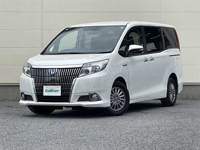 トヨタ エスクァイア ハイブリッド Gi 茨城県 2015(平27)年 5.4万km ホワイトパールクリスタルシャイン ワンオーナー/両側オートスライドドア/純正９インチナビ/フルセグテレビ/リアビューモニター/クルーズコントロール/ビルトインETC/クリアランスソナー/オートライト/純正置くだけ充電器/レザーシート/オットマン/シートヒーター/フロアマット純正/ドアバイザー