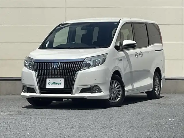 トヨタ エスクァイア ハイブリッド Gi 茨城県 2015(平27)年 5.4万km ホワイトパールクリスタルシャイン ワンオーナー/両側オートスライドドア/純正９インチナビ/フルセグテレビ/リアビューモニター/クルーズコントロール/ビルトインETC/クリアランスソナー/オートライト/純正置くだけ充電器/レザーシート/オットマン/シートヒーター/フロアマット純正/ドアバイザー