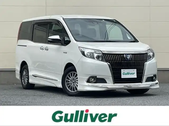 トヨタ エスクァイア ハイブリッド Gi ブラックテーラード 茨城県 2016(平28)年 4.2万km ホワイトパールクリスタルシャイン プッシュスタート/スマートキー/スペアキー/保証書付き/取扱説明書/モデリスタエアロ（前横後）/Bluetooth接続/フルセグTV/クルーズコントロール/両側パワースライド/オートマチックハイビーム/オートライト/バックカメラ/前席シートヒーター/衝突被害軽減システム/ブラックレザーシート