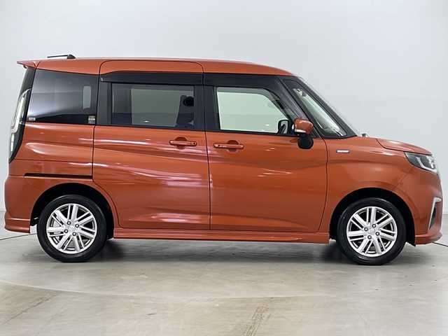 スズキ ソリオ HV MZ 道央・札幌 2021(令3)年 3.6万km フレイムオレンジPM ・4WD/・ワンオーナー/・純正ナビフルセグTV&CD&BT&USB/・全方位カメラ/・両側パワースライドドア/・HUD/・スズキセーフティサポート/・衝突軽減ブレーキ/・誤発進抑制機能/・車線逸脱抑制機能/・リヤクロストラフィックアラート/・前席シートヒーター/・アダプティブクルーズコントロール/・後方コーナーセンサー/・ステアリングスイッチ/・純正エンジンスターター/・純正フロアマット/・社外15インチAW付スタッドレス積込/・オートライト/・LEDヘッドライト/・LEDフォグ/・アイドリングストップ/・プッシュスタート/・ETC/・スマートキー
