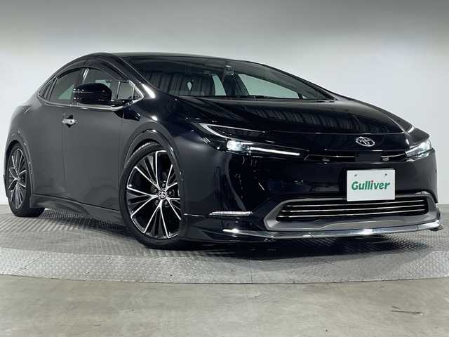 トヨタ プリウス Z 神奈川県 2023(令5)年 1.5万km アティチュードブラックマイカ モデリスタエアロ【フロント/サイド/リア】/TEIN車高調【純正サス有】/パノラマルーフ/純正１２．３型Ｄディスプレイオーディオ/純正前後ドライブレコーダー【DA連動】/純正ビルトインETC2.0【DA連動】/Tコネクトナビ　/フルセグ　Bluetooth　USB　Miracast/パノラミックビューモニター【バックカメラ洗浄機能】/トヨタチームメイト　/アドバンストＰ　/パワーバックドア/シンプルインテリジェントパーキングアシスト　/セーフティセンス/ブラインドスポットモニター/プリクラッシュセーフティ/緊急操舵支援/レーントレーシングアシスト/オートマチックハイビーム/パーキングサポートブレーキ/自動防眩ミラー/置くだけ充電/AC100V/レザーシート/前席シートヒーター＆ベンチレーション/運転席パワーシート＆ポジションメモリ/革巻きステアリング/ステアリングスイッチ/電動パーキングブレーキ/オートブレーキホールド/プッシュスタート/スマートキー/LEDヘッドランプ/純正リアスポイラー/純正19インチアルミホイール