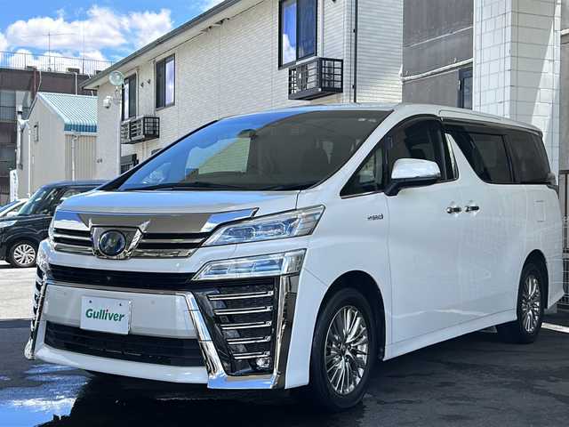 トヨタ ヴェルファイア ハイブリット Z 京都府 2019(平31)年 7.6万km ホワイトパールクリスタルシャイン 純正11インチSDナビ/フルセグTV/Bluetooth Audio/CD/DVD/Blu-ray/USB/HDMI/AUX/アラウンドビューモニター/JBLサウンドシステム/デジタルインナーミラー/フリップダウンモニター/レーダークルーズコントロール/ビルトインETC2.0/前方ドライブレコーダー(ZDR-024)/レーダー探知機/プッシュスタート/プリクラッシュセーフティシステム/パーキングサポートブレーキ/レーンキープアシスト/ロードサインアシスト/クリアランスソナー/BSM/電動パーキングブレーキ/電動格納ウィンカーミラー/オートリトラクタブルミラー/ステアリングスイッチ/オールオートパワーウィンドウ/フォグランプ