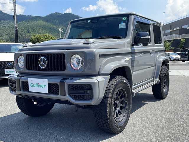 スズキ ジムニー シエラ JC 山梨県 2022(令4)年 1.5万km ミディアムグレー Gクラス仕様/社外ＳＤナビ　/バック・フロントカメラ　/純正ビルトインＥＴＣ　/ＣＤ　/Ｂｌｕｅｔｏｏｔｈ　/前後ドラレコ　/運転席／助手席シートヒーター　/背面タイヤ　/横滑り防止装置　/レーンキープアシスト　/盗難防止装置　/ＡＢＳ/シートカバー