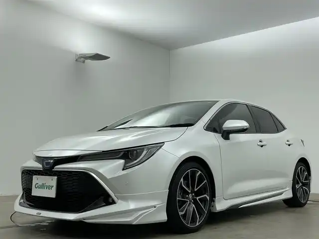 トヨタ カローラ スポーツ ハイブリッドG Z 岡山県 2020(令2)年 3.4万km プラチナホワイトパールマイカ モデリスタエアロ（フロント・サイド・リア）/ワンオーナー/純正9インチナビ/【フルセグ/Bluetooth/DVD】/純正18インチアルミホイール+サマータイヤ：装着/レーダークルーズコントロール/ビルトインETC/LEDヘッドライト（AUTO機能付き）/シートヒーター/横滑り防止機能/衝突軽減システム/車線逸脱防止システム/社外ドライブレコーダー/スマートキー/プッシュスタート/コーナーセンサー/純正フロアマット/ブラインドスポットモニター/USB接続