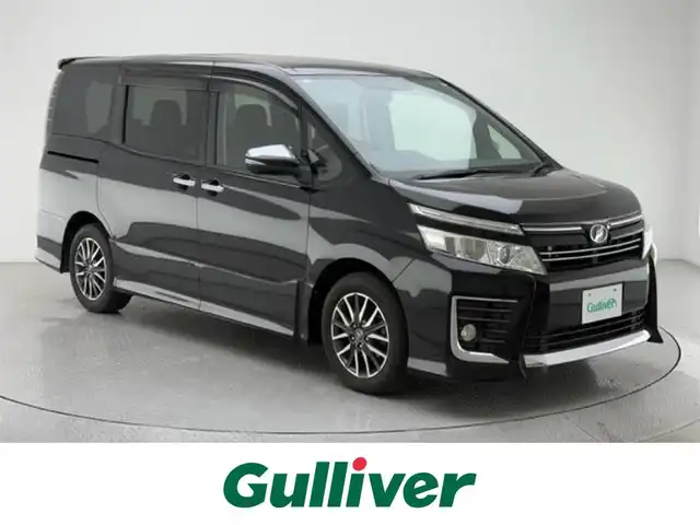 トヨタ ヴォクシー ZS 煌 兵庫県 2015(平27)年 9.2万km ブラック ALPINEナビ/（CD/DVD/Bluetooth/フルセグTV）/・EX1000/バックカメラ/横滑り防止装置/MTモード付AT/両側パワースライドドア/LEDヘッドライト/オートライト/ビルトインETC/アイドリングストップ/プッシュスタート/スマートキー/純正フロアマット/3列シート/ウォークスルー