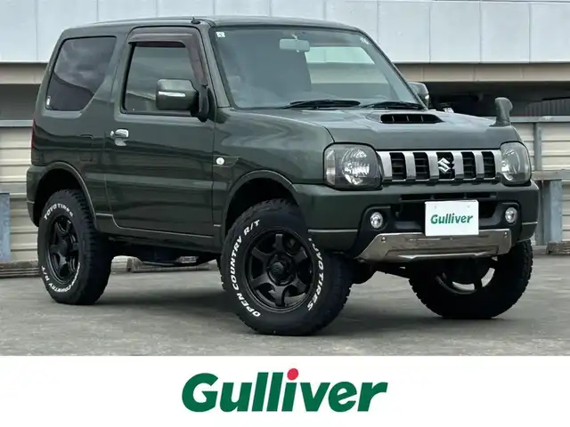 スズキ ジムニー ランドベンチャー 静岡県 2015(平27)年 9.4万km クールカーキPM 特別仕様車/５速ＭＴ/４ＷＤ/純正メモリナビ/フルセグＴＶ/ＤＶＤ再生/ＢＴオーディオ/ＥＴＣ/ハーフレザーシート/シートヒーター/背面タイヤ/ホワイトレタータイヤ/背面タイヤ・ハードカバー付き/ハロゲンヘッドライト/純正フロアマット/RAYS１６ＡＷ