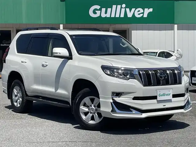 トヨタ ランドクルーザー プラド TX 千葉県 2023(令5)年 2.2万km ホワイトパールクリスタルシャイン モデリスタエアロ/モデリスタマフラー/ムーンルーフ/純正9インチSDナビ【NSZT-Y68T】/・CD/DVD/MSV/Bluetooth/フルセグTV/バックカメラ/トヨタセーフティーセンス/・プリクラッシュセーフティー/・レーンディパーチャーアラート/・オートマチックハイビーム/・ロードサインアシスト/・パーキングサポートブレーキ/・アダプティブクルーズコントロール/前後コーナーセンサー/ルーフレール/社外ドライブレコーダー/ビルトインETC/純正LEDヘッドライト/フォグランプ/純正17インチアルミホイール/サイド＆カーテンエアバッグ/新車時保証書＆取扱説明書