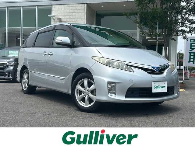 トヨタ エスティマ ハイブリッド X 鳥取県 2010(平22)年 9.9万km シルバーM ワンオーナー/社外ナビ(AVN-HS01F)/フルセグテレビ/AM/FM、CD/DVD、AUX/スマホ連動(AppleCarPlay)/HDMI/BT/バックカメラ/オットマン/クルーズコントロール/キャプテンシート/ドアバイザー/プッシュスタート/片側パワースライドドア/ETC