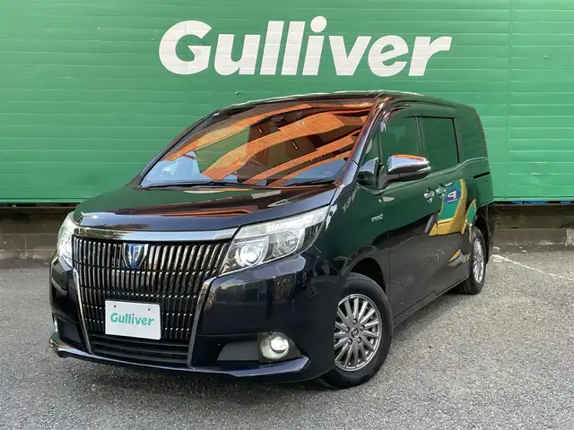 トヨタ エスクァイア ハイブリッド Gi ブラックテーラード 東京都 2016(平28)年 4.5万km スパークリングブラックパールクリスタルシャイン 純正9インチナビ（NSZT-Y66T）/・フルセグTV/DVD/Bluetoothオーディオ/両側電動スライドドア/バックカメラ/ドライブレコーダー前後/トヨタセーフティセンスC/・プリクラッシュセーフティシステム/・レーンディパーチャーアラート/・オートマチックハイビーム/合皮シート/前席シートヒーター/純正15インチアルミホイール/保証書/取扱説明書/スペアキー