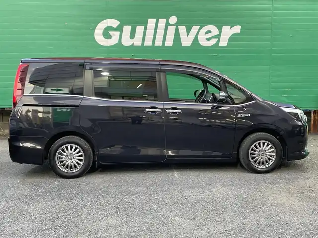 トヨタ エスクァイア ハイブリッド Gi ブラックテーラード 東京都 2016(平28)年 4.5万km スパークリングブラックパールクリスタルシャイン 純正9インチナビ（NSZT-Y66T）/・フルセグTV/DVD/Bluetoothオーディオ/両側電動スライドドア/バックカメラ/ドライブレコーダー前後/トヨタセーフティセンスC/・プリクラッシュセーフティシステム/・レーンディパーチャーアラート/・オートマチックハイビーム/合皮シート/前席シートヒーター/純正15インチアルミホイール/保証書/取扱説明書/スペアキー