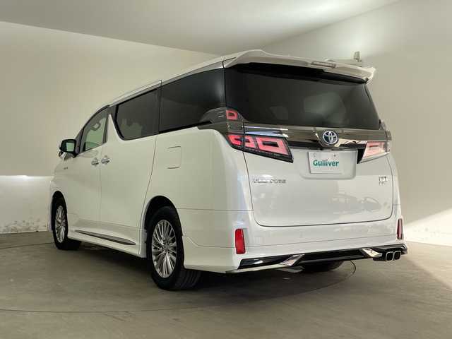 トヨタ ヴェルファイア ハイブリット Z ゴールデンアイズ 兵庫県 2021(令3)年 6.5万km ホワイトパールクリスタルシャイン ・純正ナビCD/DVD/USB/Miracast/Bluetooth/TV/HDMI/・純正フリップダウンモニター/・バックカメラ/・ビルトインETC/・モデリスタエアロ（F.S.R）/・前後ドライブレコーダー/・両側パワースライドドア/・パワーバックドア/・Toyota　Safety　Sense/・プリクラッシュセーフティ/・レーントレーシングアシスト/・レーダークルーズコントロール（全車速追従機能付）/・ロードサインアシスト/・アダプティブハイビームシステム/・先行車発進告知/・三眼ＬＥＤヘッドライト/・フォグランプ/・AC100V電源/・純正アルミホイール/・社外フロアマット/・社外レーダー探知機/・ウッドコンビステアリング/・スマートキー/・スペアキー