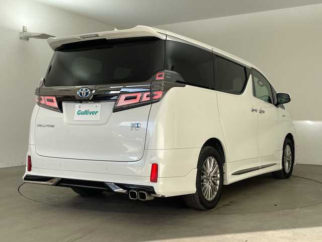 トヨタ ヴェルファイア ハイブリット Z ゴールデンアイズ 兵庫県 2021(令3)年 6.5万km ホワイトパールクリスタルシャイン ・純正ナビCD/DVD/USB/Miracast/Bluetooth/TV/HDMI/・純正フリップダウンモニター/・バックカメラ/・ビルトインETC/・モデリスタエアロ（F.S.R）/・前後ドライブレコーダー/・両側パワースライドドア/・パワーバックドア/・Toyota　Safety　Sense/・プリクラッシュセーフティ/・レーントレーシングアシスト/・レーダークルーズコントロール（全車速追従機能付）/・ロードサインアシスト/・アダプティブハイビームシステム/・先行車発進告知/・三眼ＬＥＤヘッドライト/・フォグランプ/・AC100V電源/・純正アルミホイール/・社外フロアマット/・社外レーダー探知機/・ウッドコンビステアリング/・スマートキー/・スペアキー