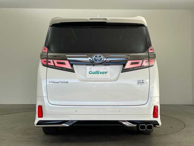 トヨタ ヴェルファイア ハイブリット Z ゴールデンアイズ 兵庫県 2021(令3)年 6.5万km ホワイトパールクリスタルシャイン ・純正ナビCD/DVD/USB/Miracast/Bluetooth/TV/HDMI/・純正フリップダウンモニター/・バックカメラ/・ビルトインETC/・モデリスタエアロ（F.S.R）/・前後ドライブレコーダー/・両側パワースライドドア/・パワーバックドア/・Toyota　Safety　Sense/・プリクラッシュセーフティ/・レーントレーシングアシスト/・レーダークルーズコントロール（全車速追従機能付）/・ロードサインアシスト/・アダプティブハイビームシステム/・先行車発進告知/・三眼ＬＥＤヘッドライト/・フォグランプ/・AC100V電源/・純正アルミホイール/・社外フロアマット/・社外レーダー探知機/・ウッドコンビステアリング/・スマートキー/・スペアキー