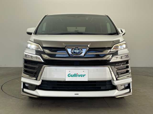 トヨタ ヴェルファイア ハイブリット Z ゴールデンアイズ 兵庫県 2021(令3)年 6.5万km ホワイトパールクリスタルシャイン ・純正ナビCD/DVD/USB/Miracast/Bluetooth/TV/HDMI/・純正フリップダウンモニター/・バックカメラ/・ビルトインETC/・モデリスタエアロ（F.S.R）/・前後ドライブレコーダー/・両側パワースライドドア/・パワーバックドア/・Toyota　Safety　Sense/・プリクラッシュセーフティ/・レーントレーシングアシスト/・レーダークルーズコントロール（全車速追従機能付）/・ロードサインアシスト/・アダプティブハイビームシステム/・先行車発進告知/・三眼ＬＥＤヘッドライト/・フォグランプ/・AC100V電源/・純正アルミホイール/・社外フロアマット/・社外レーダー探知機/・ウッドコンビステアリング/・スマートキー/・スペアキー
