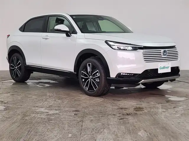 ホンダ ヴェゼル ハイブリッド e:HEV Z 愛知県 2025(令7)年 0.1千km プラチナホワイトパール 登録済未使用車/ホンダセンシング/　・衝突軽減ブレーキ（CMBS）/　・渋滞追従機能付アダプティブクルーズコントロール（ACC）/　・車線維持支援システム（LKAS）/　・ブラインドスポットインフォメーション/　・誤発進抑制機能/純正ディスプレイオーディオ/　（AppleCarPlay/AndroidAuto対応）/バックカメラ/ＥＴＣ２．０/置くだけ充電/パワーバックドア/前席シートヒーター/スマートキー×２/純正１８インチアルミホイール