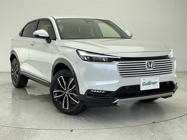 ホンダ ヴェゼル ハイブリッド e:HEV Z 千葉県 2025(令7)年 0.1千km プラチナホワイトパール ブラインドスポットモニター/レーダークルーズコントロール/レーンキープアシスト/コーナーセンサー前後/衝突軽減ブレーキ/純正メモリナビ/　AppleCareplay/AndroidAuto/　Bluetooth/フルセグTV/バックカメラ/ビルトインETC2.0/ワイヤレス充電/パドルシフト/電動リアゲート/ハーフレザーシート/シートヒーター（D/N席）/LEDヘッドライト/オートライト/純正18インチアルミホイール