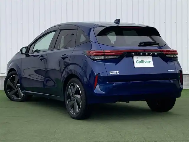 日産 オーラ G  90周年記念車 香川県 2024(令6)年 1万km 青 登録時走行距離：9959ｋｍ/純正ナビゲーション/→CD/DVD再生/→フルナビTV/全方向カメラ/ステアリングヒーター/ステアリングリモコン/革巻きステアリング/オートブレーキ/LEDオートヘッドライト/オートハイビーム/純正17インチアルミホイール/電格ウィンカーミラー/ブレーキアシスト/盗難防止装置/スマートキー