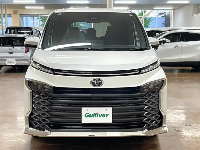 トヨタ ヴォクシー S－G 道央・札幌 2024(令6)年 1.8万km ホワイトパールクリスタルシャイン 4WD/寒冷地仕様/純正8インチナビ/・フルセグTV/CD/DVD/BT/USB/バックカメラ/両側パワースライドドア/トヨタセーフティセンス/・プリクラッシュセーフティ/・レーントレーシングアシスト/・レーンディパーチャーアラート/・ロードサインアシスト/・プロアクティブドライビングアシスト/・発進遅れ告知機能/・緊急時操舵支援/・低速時加速抑制機能/横滑り防止装置/前後コーナーセンサー/電動パーキングブレーキ/ブレーキホールド/レーダークルーズコントロール/ETC/オートライト/アダプティブハイビーム/LEDヘッドライト/ステアリングリモコン/フロアマット/3列シート/プッシュスタート/スマートキー/ヘッドライトレベライザー/ウインカーミラー/純正16インチAW/新車時保証書/取扱説明書