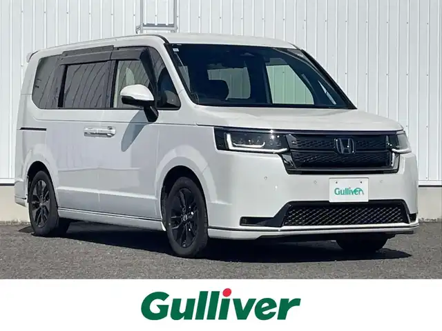 ホンダ ステップワゴン スパーダ eHEV 熊本県 2024(令6)年 0.5万km プラチナホワイトパール 純正ナビ/・BT/USB/SD/AM/FM/・フルセグTV/ホンダセンシング/バックカメラ/ビルトインETC/アダプティブクルーズコントロール/両側パワースライドドア/前後ドラレコ/D/Nシートヒーター/プッシュスタート/・スマートキー/純正AW/革調シートカバー/電動格納ミラー/・ミラーウィンカー
