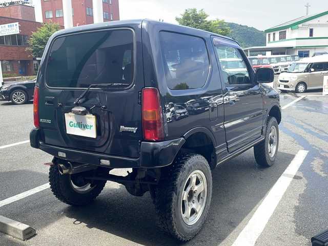 スズキ ジムニー FISフリースタイルワールドC LTD 京都府 2004(平16)年 10.5万km ブルーイッシュブラックパール3 ４WD/ターボ/5速マニュアル/社外HDDナビ/リフトアップ/社外マフラー/ETC/リモコンキー/社外16インチアルミ/革巻きステアリング