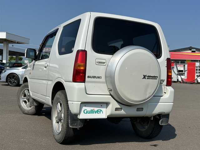 スズキ ジムニー クロスアドベンチャー XC 道東・釧路十勝 2010(平22)年 15.9万km パールホワイト 4WD/ターボエンジン/レザーシート/革巻きステアリング/社外SDナビ/フルセグTV/16インチAW/背面タイヤ/夏タイヤ積込み/シートヒーター(D席)/パワーウィンドウ/パワーステアリング/純正タイヤキャップ/純正フロアマット/社外ドアバイザー/取扱説明書/保証書