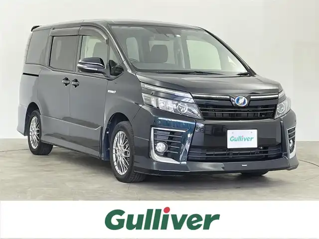 トヨタ ヴォクシー ハイブリッド ZS 千葉県 2016(平28)年 6.4万km ブラッキッシュアゲハガラスフレーク 純正10型ナビ/（AM＆FM＆Bluetooth＆フルセグTV＆CD＆DVD）/モデリスタエアロ（F）/トヨタセーフティセンス/両側電動スライドドア/衝突軽減ブレーキ/禁煙　/ビルトインＥＴＣ　/オートマチックハイビーム　/社外後席モニター　/レーンディパーチャーアラート/ＬＥＤヘッドライト（オートライト付き）/電動格納サイドミラー　/リアサンシェード/アイドリングストップ/ウィンカーミラー/ドアバイザー/プッシュスタート/12Vシガーソケット/ステアリングスイッチ/ISOFIX