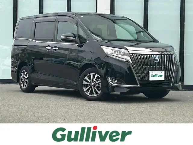 トヨタ エスクァイア ハイブリッド Gi プレミアムパッケージ ブラックテーラード 大阪府 2021(令3)年 1.4万km ブラック 純正１０インチナビ/  フルセグTV/CD/DVD/Bluetooth/USB/衝突軽減/バックモニター/１２インチ後席モニター/前席シートヒーター/両側パワースライドドア/クルーズコントロール/ドライブレコーダー/コーナーセンサー/純正15インチアルミホイール/純正フロアマット/100V電源/スマートキー/ワンオーナー/ＥＴＣ/ＬＥＤライト